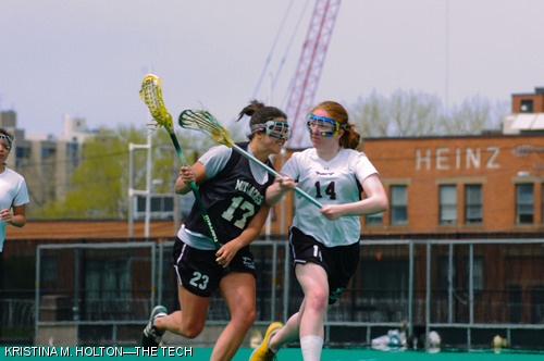 Assistant Coach Vanessa M. Cox (left) and Laura C. Watson '08 (right) play against each other in the MIT women's lacrosse Alumni Game on Saturday, May 5 on Briggs Field.