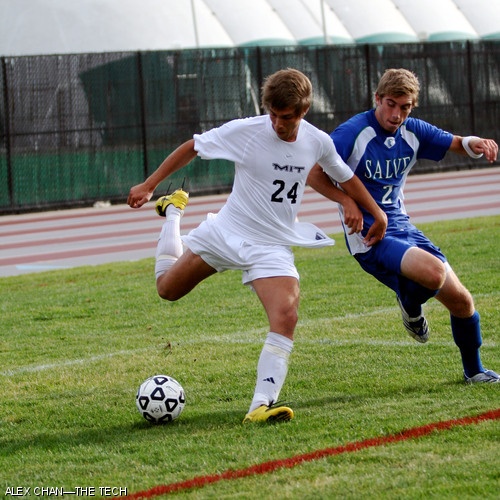 Christian W. Therkelsen ’11 (left) passes the ball as Gregory Cannon from Salve Regina tries to block.