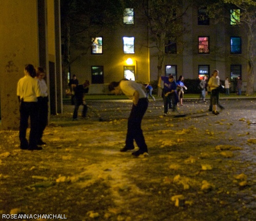 Spectators gather at the base of the Green Building to examine what happens when speeding pumpkins hit the ground.