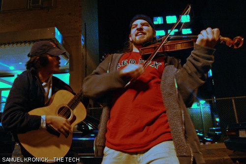 Berklee College of Music students Stash Wyslough (left) and Andy Reiner (right) celebrate the Red Sox World Series victory by jamming in the streets of Boston. See more photos on pages 10–11.