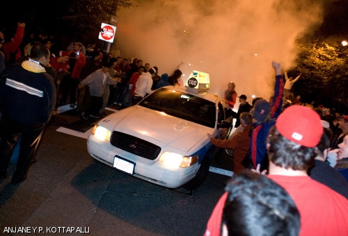 Revelers stop a passing cab and rock it until smoke pours from the tailpipe. The Boston Red Sox defeated the Colorado Rockies 4-3 on Sunday night, claiming their second World Series win in the past four seasons.