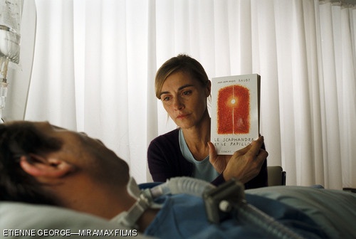 Claude, Jean-Dominique Bauby’s transcriber (played by Anne Cosigny), shows Bauby (Mathieu Amalric) his finished work in “The Diving Bell and the Butterfly.”