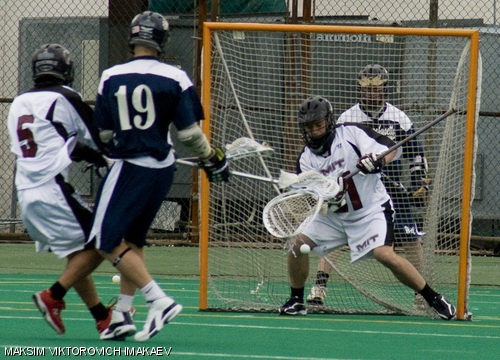 Goalkeeper Garth S. Grove ’10 defends the net against a Massachusetts Maritime attackman’s shot, contested by Dylan F. Roden ’09, during an April 5 home game. The Engineers lost 7-5.