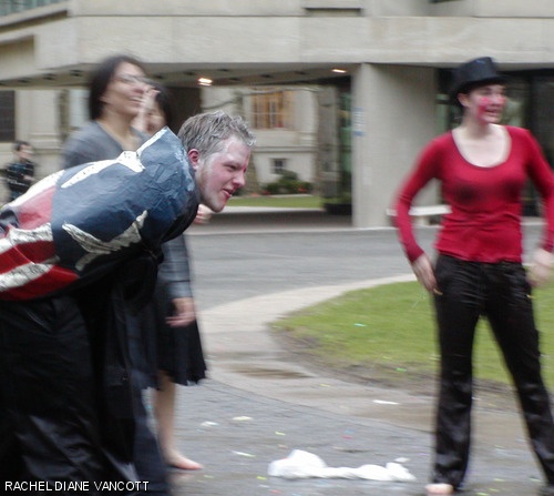 Erik D. Fogg (foreground) ’09 of Senior House surrenders to East Campus during the dorms’ water war on McDermott Court last Friday.