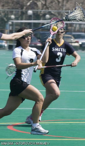 Lily He ’09 runs through Smith College defenders Sara Smyth (left) and Caitlin Kennedy during the Engineers’ 18-7 victory on Saturday on Jack Berry Field. Lily He scored two goals in the game.