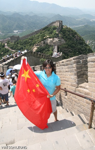 Alex H. Chan poses with a Chinese flag on the Great Wall in Beijing, China.