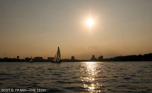 Boats sail on the Charles River as the sun sets last Saturday evening. Last weekend was a three-day holiday for students.