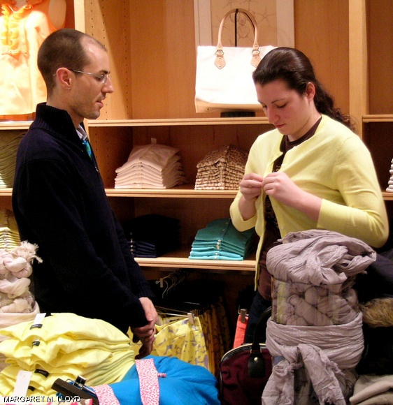 Christina A. Margiotta ’11 tries on a yellow cardigan at J.Crew as personal shopper Topher Yandell offers helpful advice. About 30 MIT students participated in Charm School’s Dress for Success event on Jan. 28.