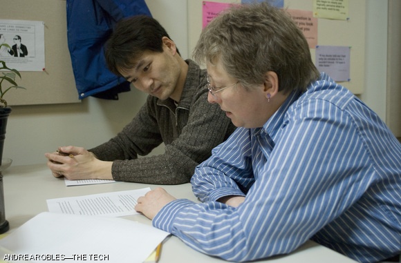 Writing tutor Susan Spilecki works on an essay with graduate student Masafumi Hashimoto on April 16. Institute-wide cuts could affect communication departments at MIT.