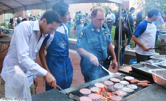 Sergeant Richard M. Sullivan of the MIT Campus Police is seen grilling hamburgers at the Rock N’ Roast Orientation BBQ held at the Sidney-Pacific graduate dormitory on Tuesday.