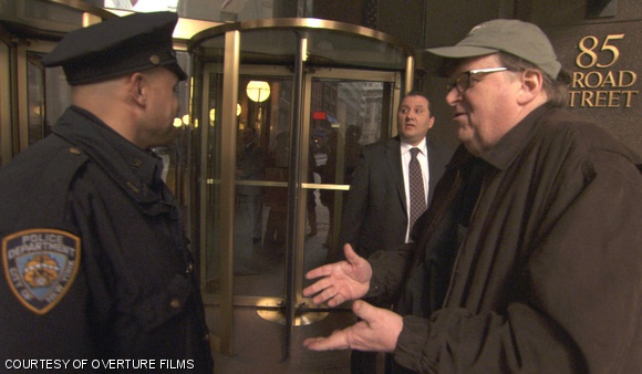 Michael Moore stands outside of Goldman Sachs headquarters in Manhattan. Wall Street is among the targets of Moore’s new film, Capitalism: A Love Story.