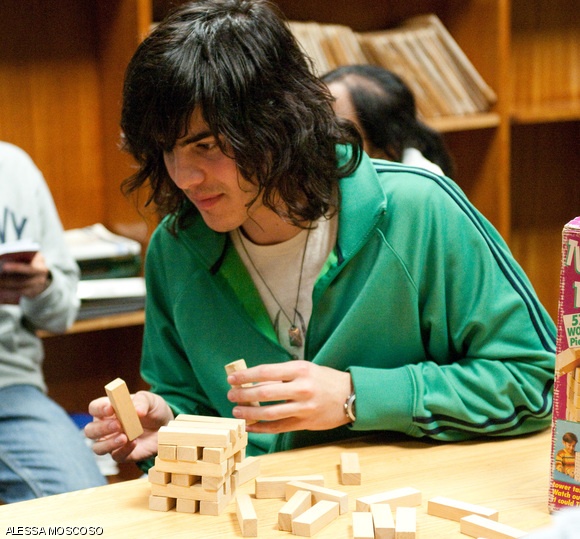 Giuseppe Zingales, a prospective freshman, plays Jenga on Thursday at McCormick.