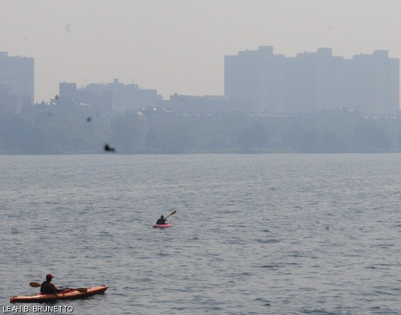 Kayakers paddle through the Charles River against the smoke-obscured Boston skyline on May 31. Smoke from forest fires in Quebec drifted through Boston, making breathing uncomfortable outdoors.