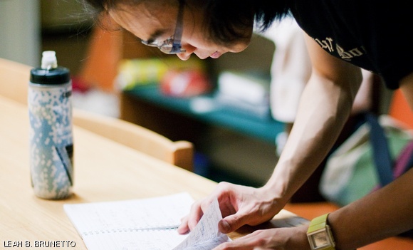 In preparation for filming the scene in which Lady Gaga prepares a sandwich, Yu-Pu intently studies his notes describing the choreography for the accompanying dance sequence.