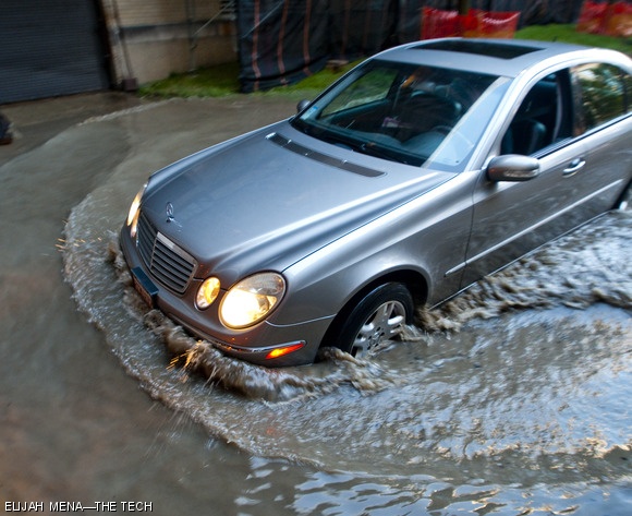 A car sloshes through the underpass at the intersection of Buildings 7 and 3, where the flooding on Thursday evening was worst. Gushing out of a burst pipe underground, the water was nearly 1.5 feet deep.