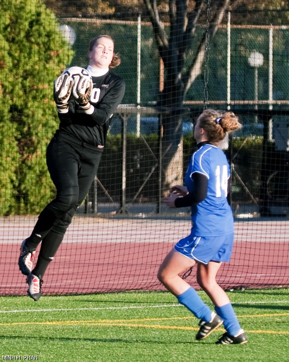 Meghan S. Wright ’13 makes a save against a Wellesley College attacker during Tuesday’s NEWMAC quarterfinals game.