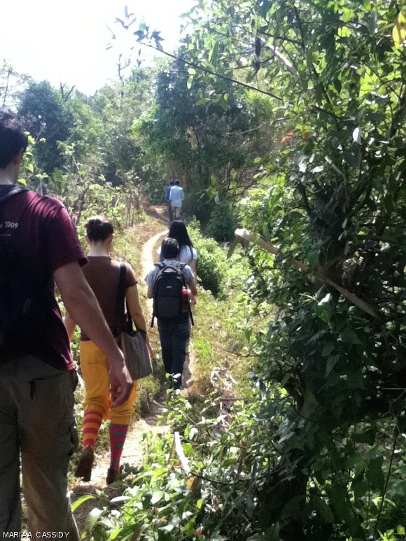 Terrascope students follow farmers of the Hallusarige Village in India through uncultivated land as part of their field work.