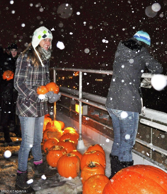 First West Hall Chair Samantha R. Hagerman ’14 prepares to toss a pumpkin over the edge of the Green Building roof.