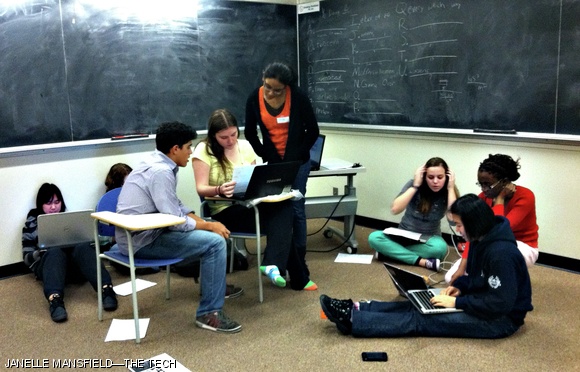 Members from the team “Freshman 15” work in Building 34 to solve puzzles Saturday evening. Each team has a headquarters in separate bases located throughout MIT.
