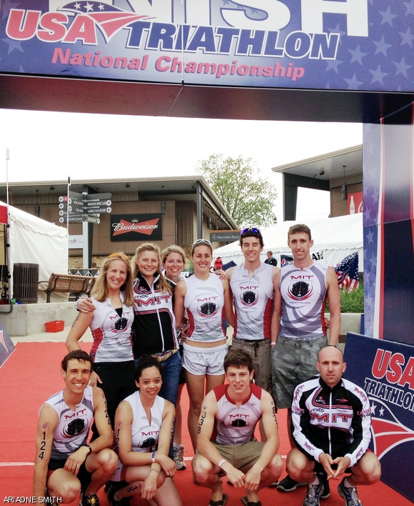 The MIT Triathlon Club poses beneath the finishing chute at the USA Triathlon Collegiate National Championships.