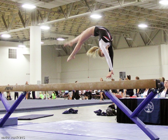 Lindsay M. Sanneman ’14 performs a back handspring on the beam.