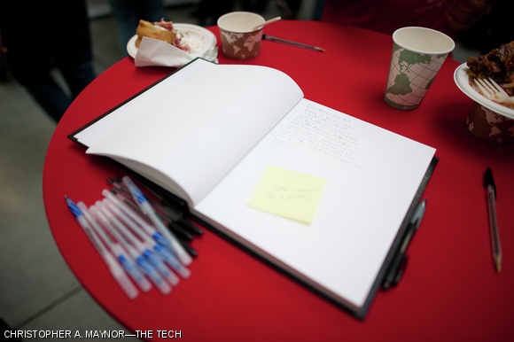 Student well-wishers left messages for the new president in a guestbook at a Stata Center meet-and-greet event.