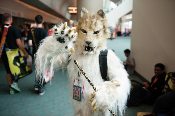 An anthropomorphic saber-tooth tiger growls at passerby at Comic-Con.