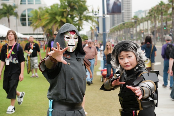 Cosplayers dressed as Amon and Chief Lin Beifong from The Legend of Korra pose for the camera.