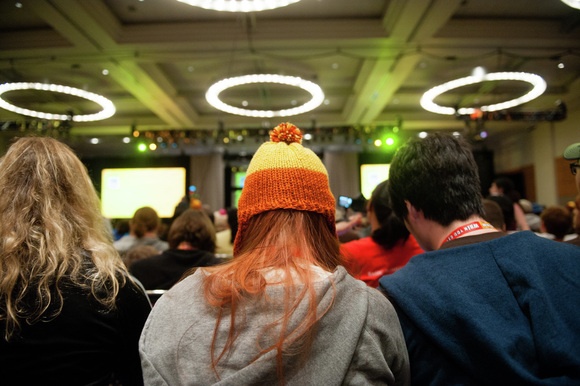 A girl awaits the Firefly reunion panel at Comic-Con, wearing a distinctive “Jayne” hat from the show.