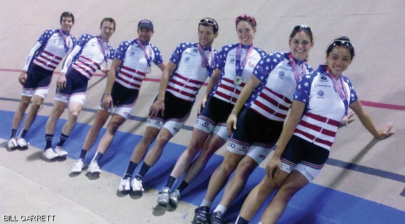 The victors sport their Stars and Bars National Championship jerseys and gold medals while leaning against the 44.6-degree velodrome racing surface.