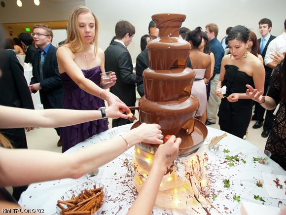 A group of students eat from a chocolate fountain at the freshman Snowflake Ball event in the Media Lab, organized by the 2015 Class Council.