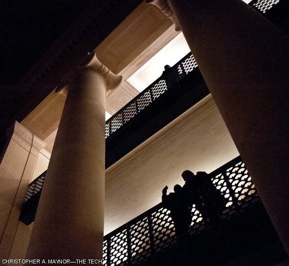 People overlooking Lobby 7 stand silhouetted against emergency lights.