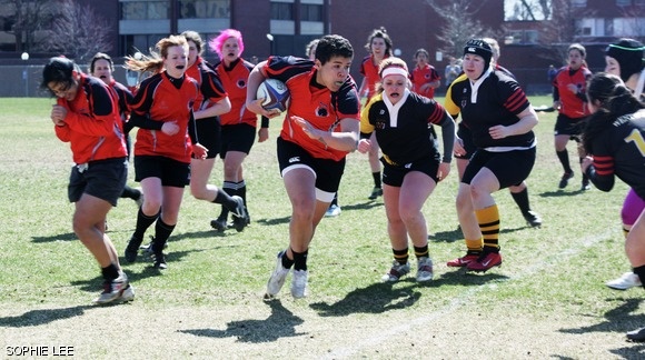 Kyra Horne ’15 runs the ball past two defenders during the women’s rugby game versus Wentworth Institute of Technology this past Saturday. MIT won 53-10.