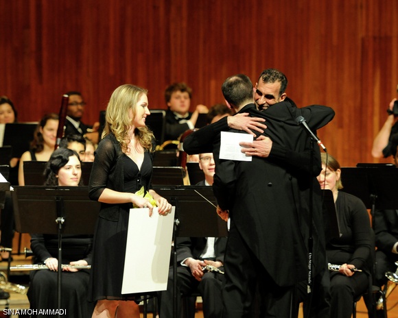 MIT Wind Ensemble Director Dr. Fredrick Harris and flutist Emily L. Jackson ’12 congratulate composer Jamsheid Sharifi ’83 after a performance of Awakening.