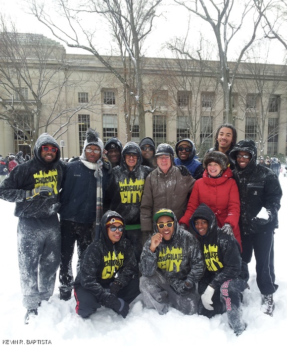 President L. Rafael Reif and his wife Christine join the brothers of Chocolate City for a photo-op amidst the chaos of the campus-wide snowball fight on Saturday in Killian Court.
