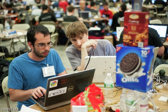 Julian Ceipek and Matthew Wismer from Olin College work out some bugs in their code.