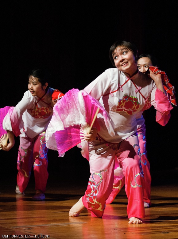 Beipeng Mu G (left) and Xiaoyue Xie ‘14 (right) use fans and handkerchiefs to emulate the beauty of the orchid flower in a Jiaozhou Yangge piece.
