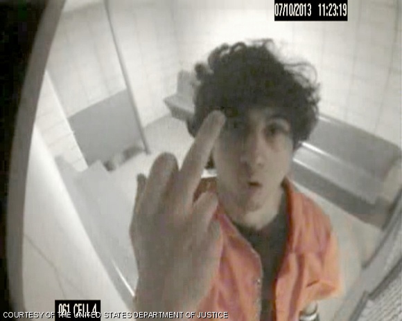 Dzhokhar Tsarnaev flashes his middle finger at the camera in a 2013 image shown to jurors on Tuesday.