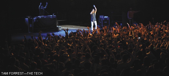 Artist Lupe Fiasco leads the crowd in a dance.