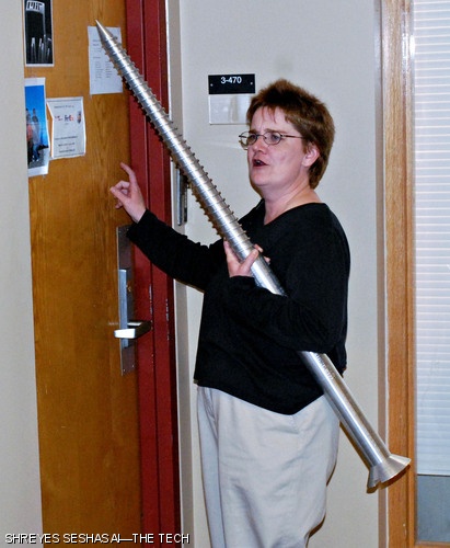 Maureen R. Lynch, Design and Manufacturing I (2.007) course administrator, knocks on the doors of mechanical engineering graduate students after being awarded the Big Screw by Alpha Phi Omega. Upon winning the award, Lynch led a victory parade through Building 3.