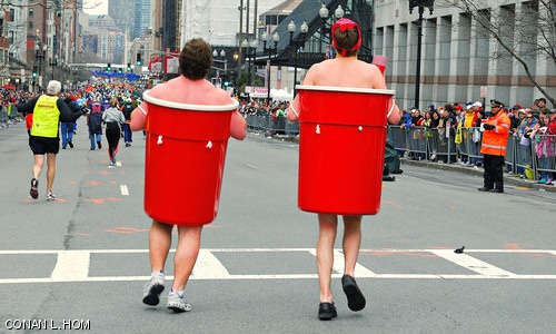Glenn J. Geesman '09 (left) and Willard J. Johnson '09 (right) round Hereford Street onto Boylston Street to complete the final stretch of the 111th Boston Marathon on Monday. Geesman and Johnson both ran the marathon dressed in large red Solo Cups.