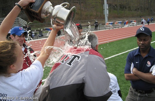 A coach from the U.S. Coast Guard Academy looks on as Rachel M. Niehuus ’07 dumps a trophy-full of cold water on Fletcher A. Brooks, head coach of the women’s track and field team. Both the men’s and women’s teams placed first in the New England Women’s and Men’s Athletic Conference championship, held this past weekend at the U.S. Coast Guard Academy.
