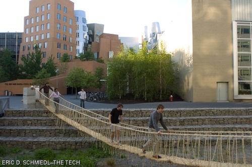 (left to right) Chienchuan Chen G, Marissa G. Desmond G, Charles Curran G, and Ian Kaminski-Coughlin cross an all-fiber bridge built across the Stata Moat by students in Materials in Human Experience (3.094). The bridge is modeled on those built by the Incas in the high Andes of Peru.