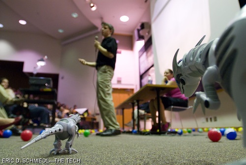 Among the dinosaurs that menaced xkcd artist Randall Munroe during his lecture at MIT were a pair of radio-controlled velociraptors that occupied a right-hand portion of the stage. When the velociraptors moved towards Munroe, the artist reached for the squirt gun loaded with grape juice that had been conveniently provided.
