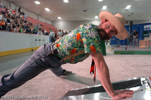 Professor Alexander H. Slocum PhD '85 does one-armed pushups in a Hawaiian shirt. Push-ups are a regular part of the annual competition.