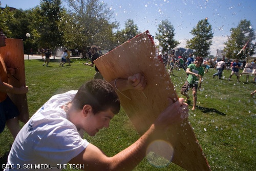 A west campus student narrowly deflects a water balloon at Monday’s annual East vs. West Water War at the Kresge Barbecue Pits.