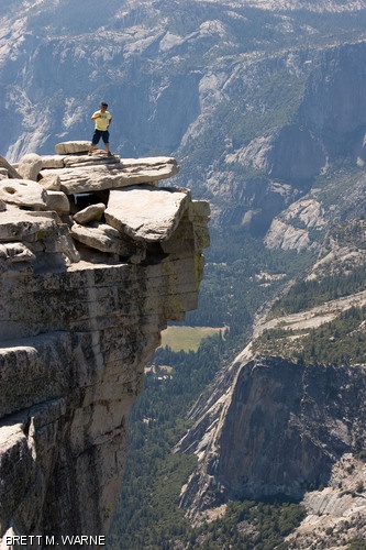 YOSEMITE, CALIF.—Staff Photographer Ray C. He G basks in triumph atop the 8,000-ft. high Half-Dome at Yosemite National Park in California. A popular destination for hikers, the Half-Dome can be reached via an 8-mile hike through the national park and a 400-ft. climb on cables. This photo is part of a series that showcases the summer adventures of Tech staff members.
