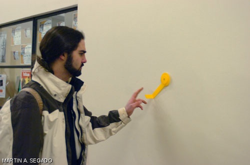Matthew N. Faulkner '08 plays with one of the many yellow cranks that appeared around campus as part of Sunday's hack.