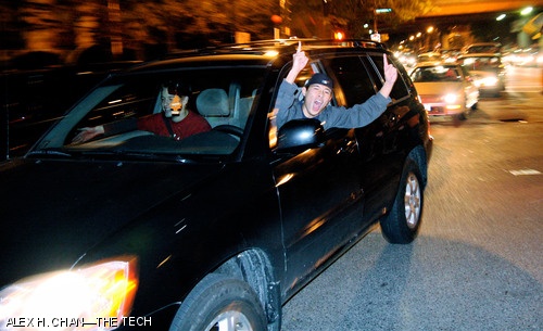 A enthusiastic driver leans out the window of his car while stopped on Bay Street Road near Kenmore Square shortly after the last game ended. The Sox defeated the Colorado Rockies 4-3 Sunday night, claiming their second World Series win in the past four seasons.