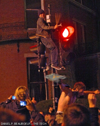 An ad hoc street musician beats on a traffic light with a drumstick in Kenmore Square. The Boston Red Sox defeated the Colorado Rockies 4-3 on Sunday night, claiming their second World Series win in the past four seasons.